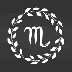 Chalk drawing flat scorpio symbol in rustic floral wreath