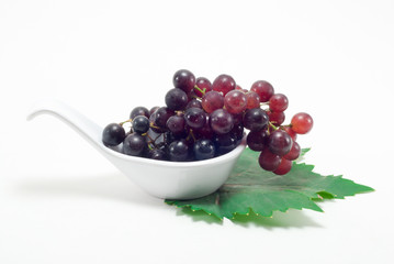 Grapes in a white spoon
