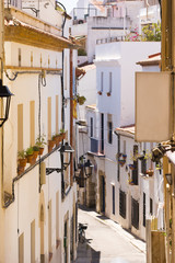 Fototapeta na wymiar Little street of the historic city center Sitges, Barcelona, Catalunya, Spain. Vertical.