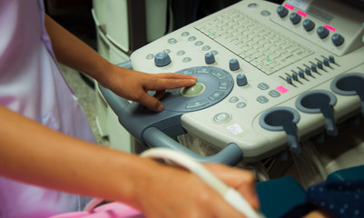 Medicine doctor working with ultrasound machine scan abdomen of patient in examination room in the hospital.