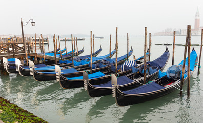 Gondola moored at dock in Venice.