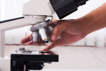 Doctor hand with microscope in laboratory room. Scientific research