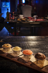 mixed freshly baked muffins in cozy coffeeshop interior