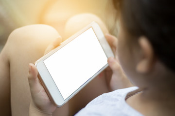 Asian kid girls are using a smartphone.