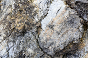 Rock texture and surface background. Cracked and weathered natural stone background.