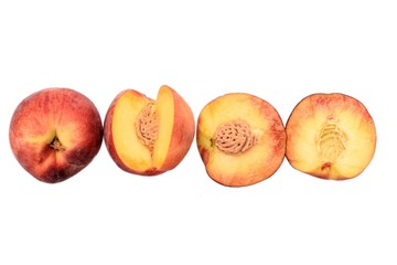 Peaches whole and sliced halves with a bone isolated on white background