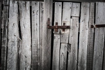 Rusty hasp on the doors of an old wooden shed, grunge style