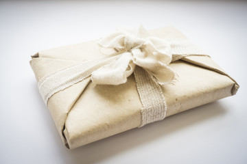 The package with eco vintage paper and linen tape and bow for a gift