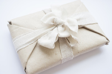 The package with eco vintage paper and linen tape and bow for a gift