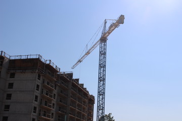 Fototapeta premium Crane Building a high rise apartment building