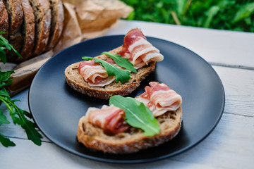 Bread with ham and herbs on a plate.