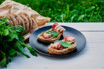 Bread with ham and herbs on a plate.