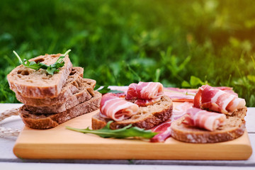 Bread with gourmet meat on a wooden desk.