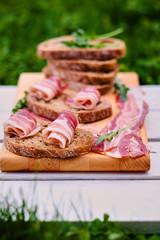 Bread with gourmet meat on a wooden desk.