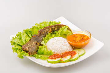 Isolated catfish fried ala Indonesia with condiments, Indonesian food