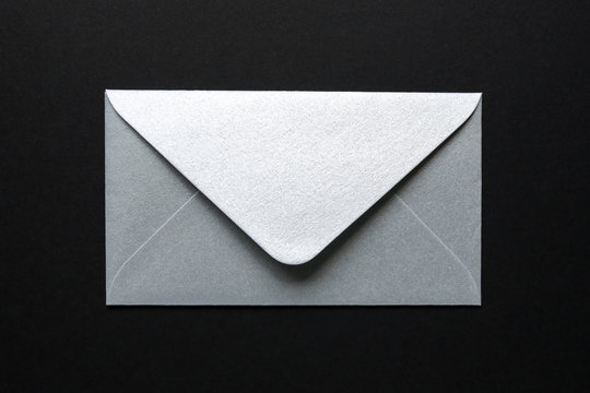 silver envelope on black background