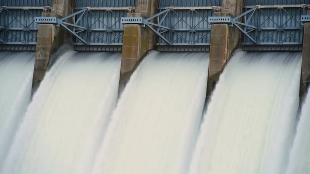 Close up of locks of a dam flowing water like a waterfall