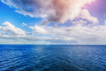 Shot of row of floating wind turbines