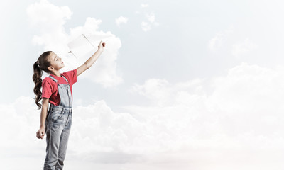 Concept of careless happy childhood with girl dreaming to become