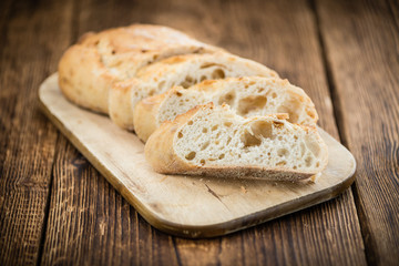 Fresh baked Baguette on wooden background (selective focus)