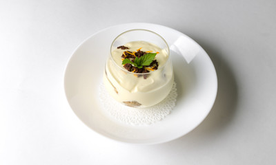 Dessert tiramisu with mint in a transparent glass