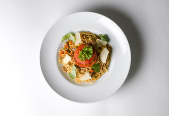 Spaghetti with parmesan cheese on a white plate