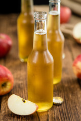 Apple Cider on wooden background (selective focus)