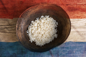 Poverty concept, bowl of rice with Netherlands flag