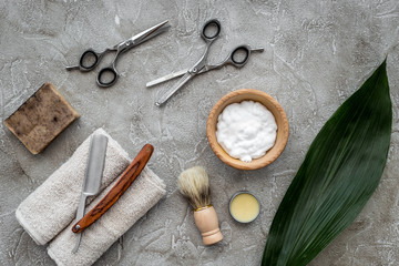 Fototapeta na wymiar Accessories for shaving. Shaving brush, razor, foam, sciccors on grey stone table background top view