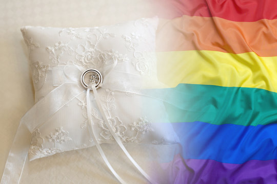 Wedding rings with rainbow flag on a pillow