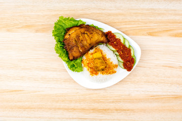 Isolated chicken fried ala Indonesia with condiments, Indonesian food