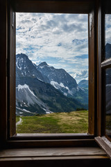 Looking through a wooden window frame to see the mountains of the Karwendelgebirge