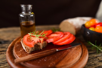 Olive oil and sandwich with tomatoes