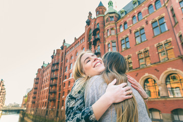 Happy girls embracing and cuddling in Hamburg