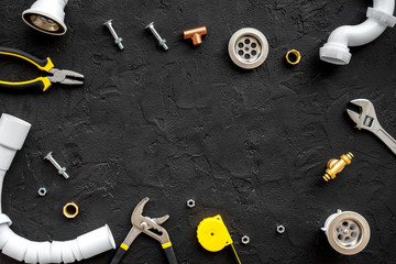 Plumber tools on black background top view copyspace
