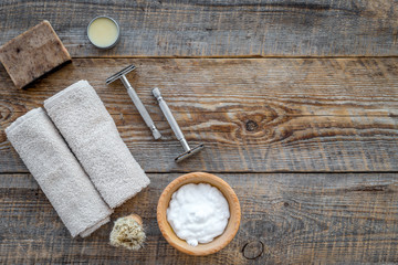 Preparing for men shaving. Shaving brush, razor, foam on wooden table background top view copyspace