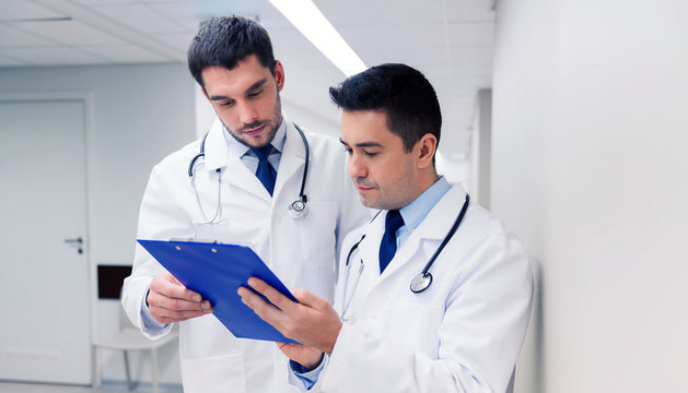two male doctors with clipboard at hospital