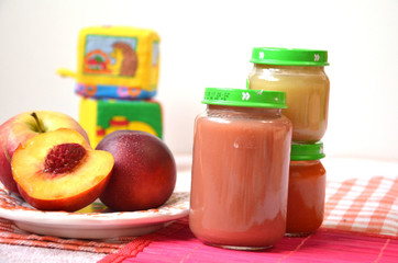 baby food, baby fruit mashed in a glass jar, peach