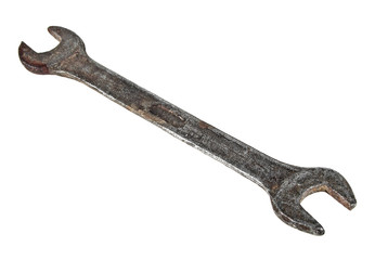 Old rusty spanner on bright background