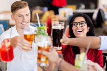friends clinking glasses with drinks at restaurant