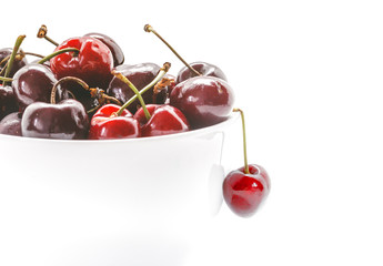 Obraz na płótnie Canvas Cherries in bowl. Closeup of Fresh cherries isolated on white background.