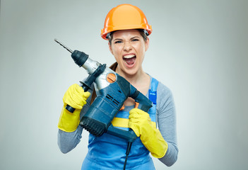 Hard work of woman builder with drill tool.
