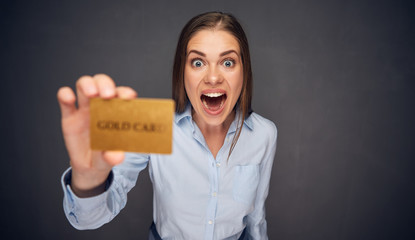 Surprised woman with open mouth holding credit card.