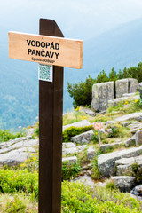The wooden sign informs of Pancava Waterfall