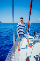 Young man sailing yacht