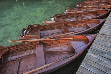 Wooden boats at the pier on the lake in the evening light.