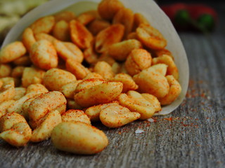 Delicious peanuts in a paper bag. Macro.