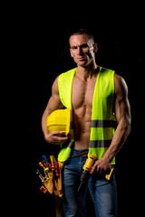 fit shirtless worker with tools