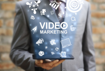 Video Marketing Online Business concept. Man represent tablet computer with video marketing icon on...
