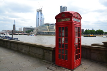 London - red telephone box and Thames river